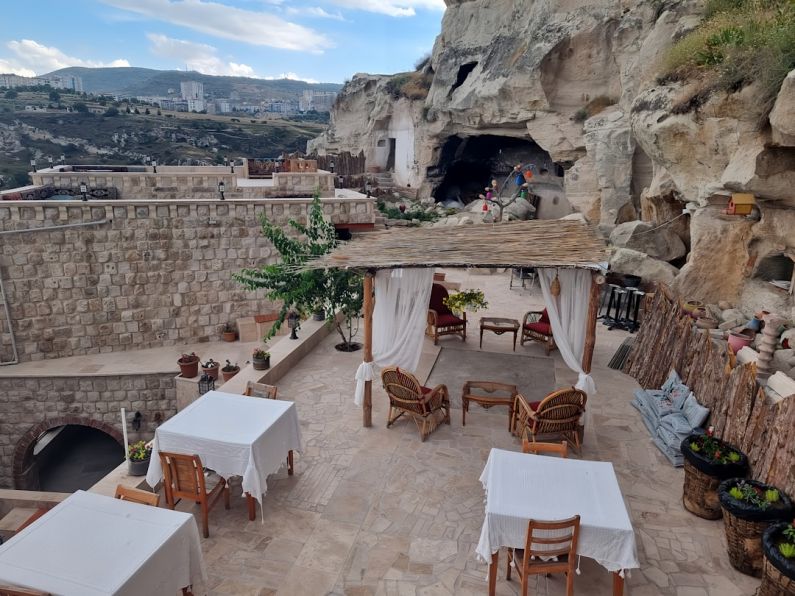 Unique Stays - an outdoor dining area with tables and chairs