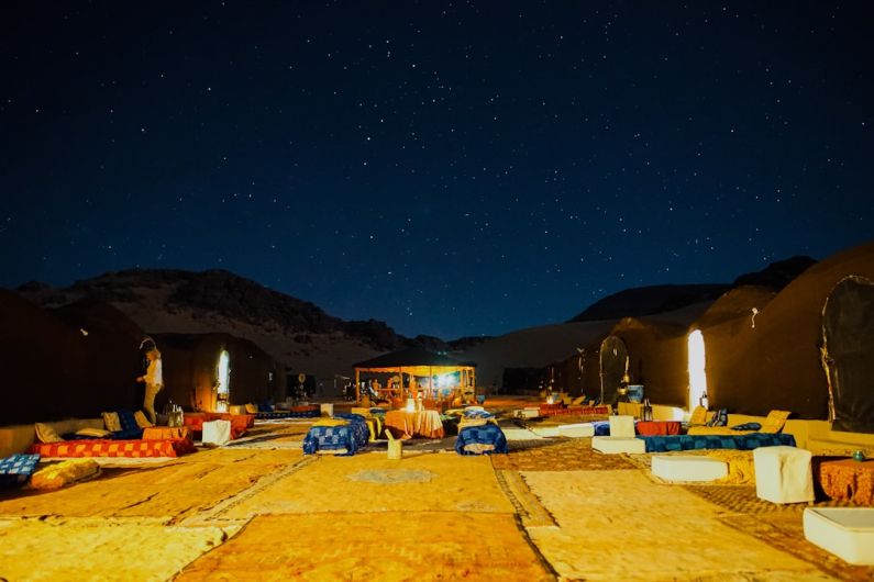 Camping Sites - lined up outdoor beds under starry night