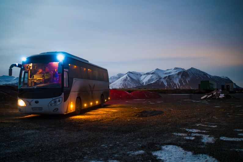 Bus - white and black bus running near the mountain