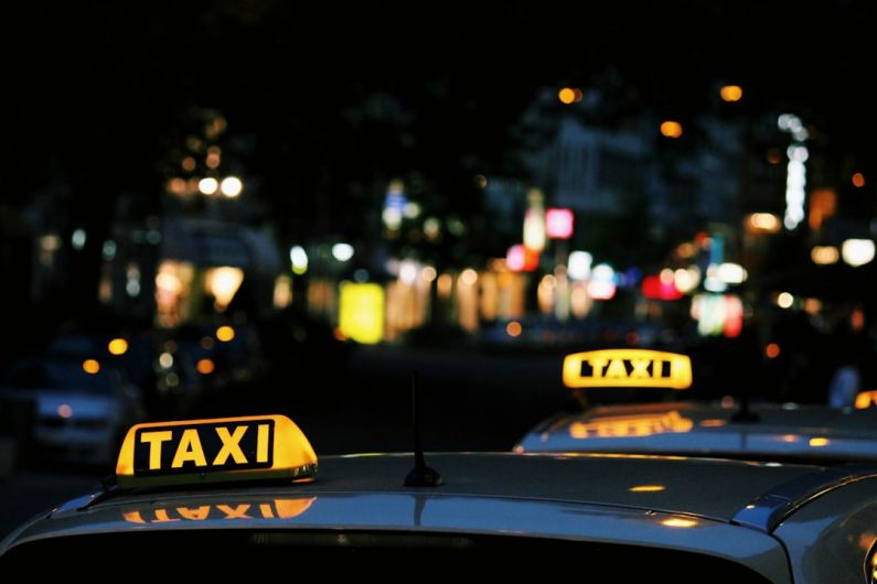 Taxi - shallow focus photography of Taxi signage