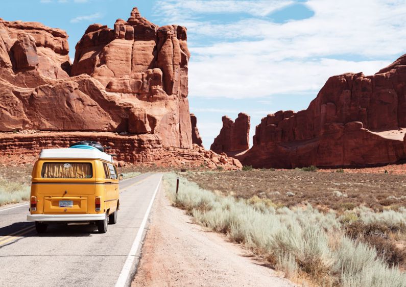 Road Trip - yellow Volkswagen van on road