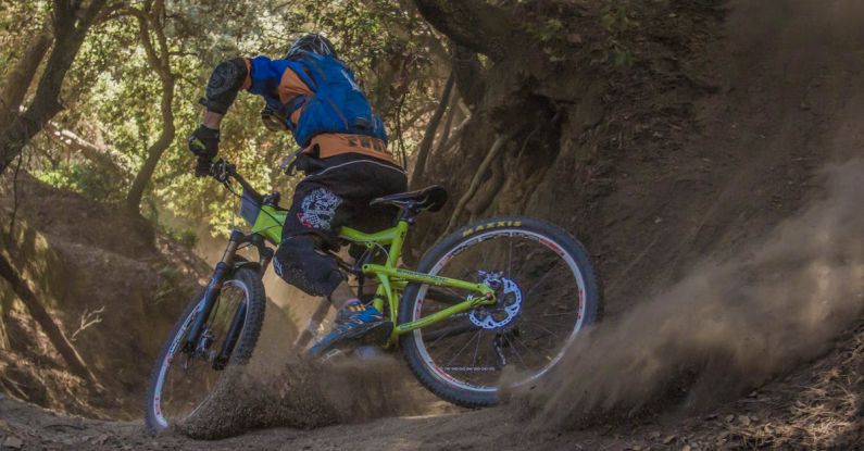 Mountain Biking - Man in Black and Orange Bicycle Riding Jacket With Green Off Road Bike