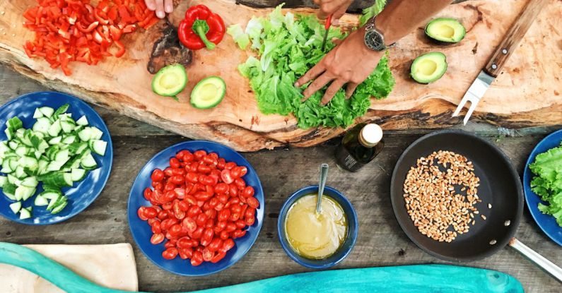 Vegetarian Restaurants - Person Holding Sliced Vegetable