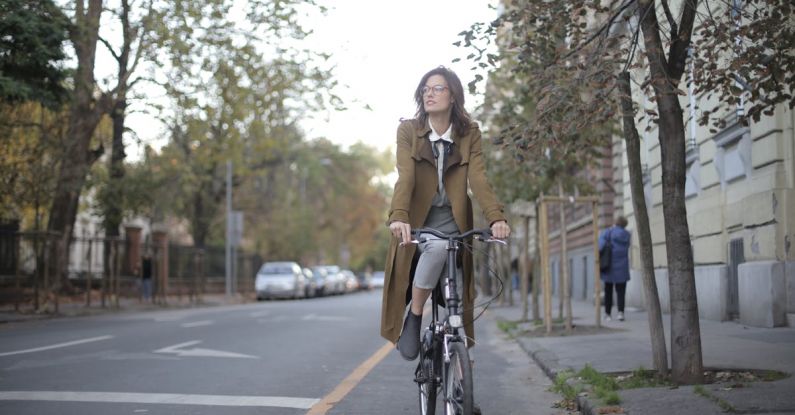 Short Trip - Woman In Brown Coat Riding a Bicycle