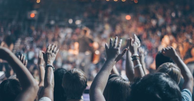 Churches - Group of People Raise Their Hands on Stadium