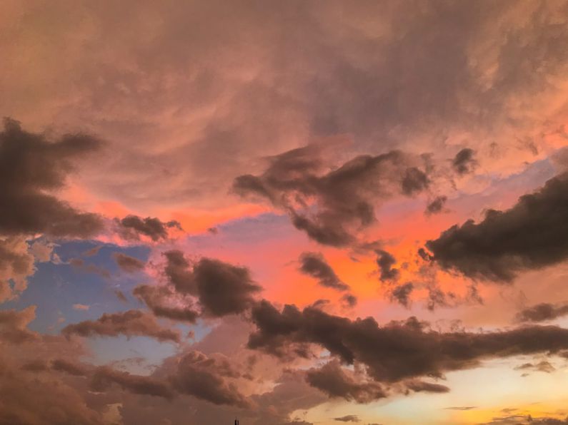 Laguna Lachua - a sunset with clouds and a plane flying in the sky