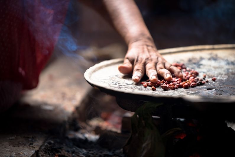 Cobán - person holding white ceramic plate with brown food