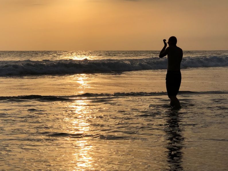 Champerico Beach - silhouette of woman standing on beach during sunset